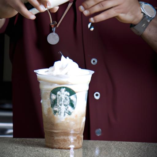 A Starbucks barista blending a Frappuccino in a blender.