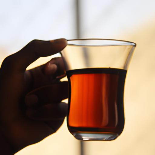 A person holding a cup of black tea. How much caffeine is in black tea?